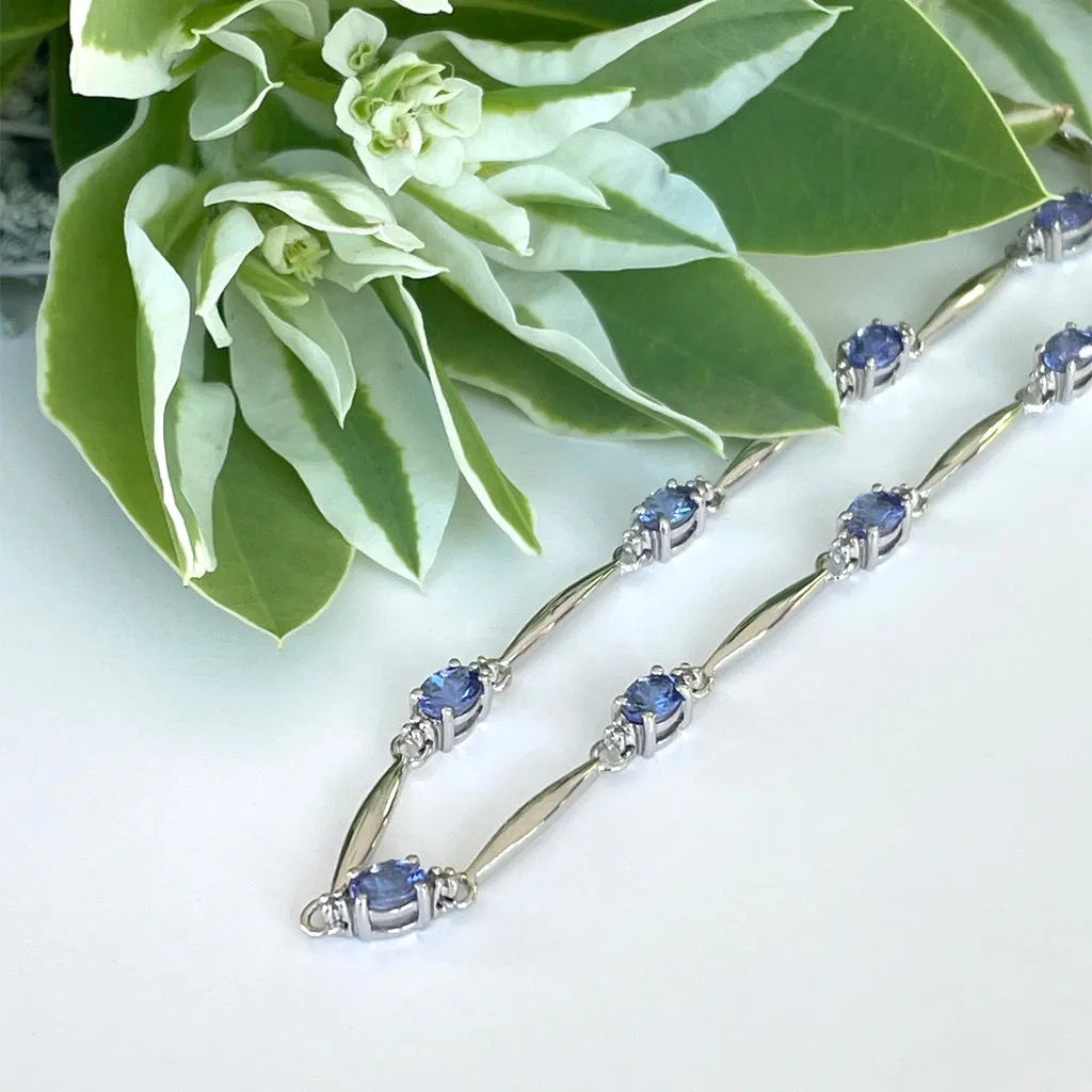 Silver Single Wave Oval Cut Tanzanite and Petite Silver Topaz Highlight Bracelet