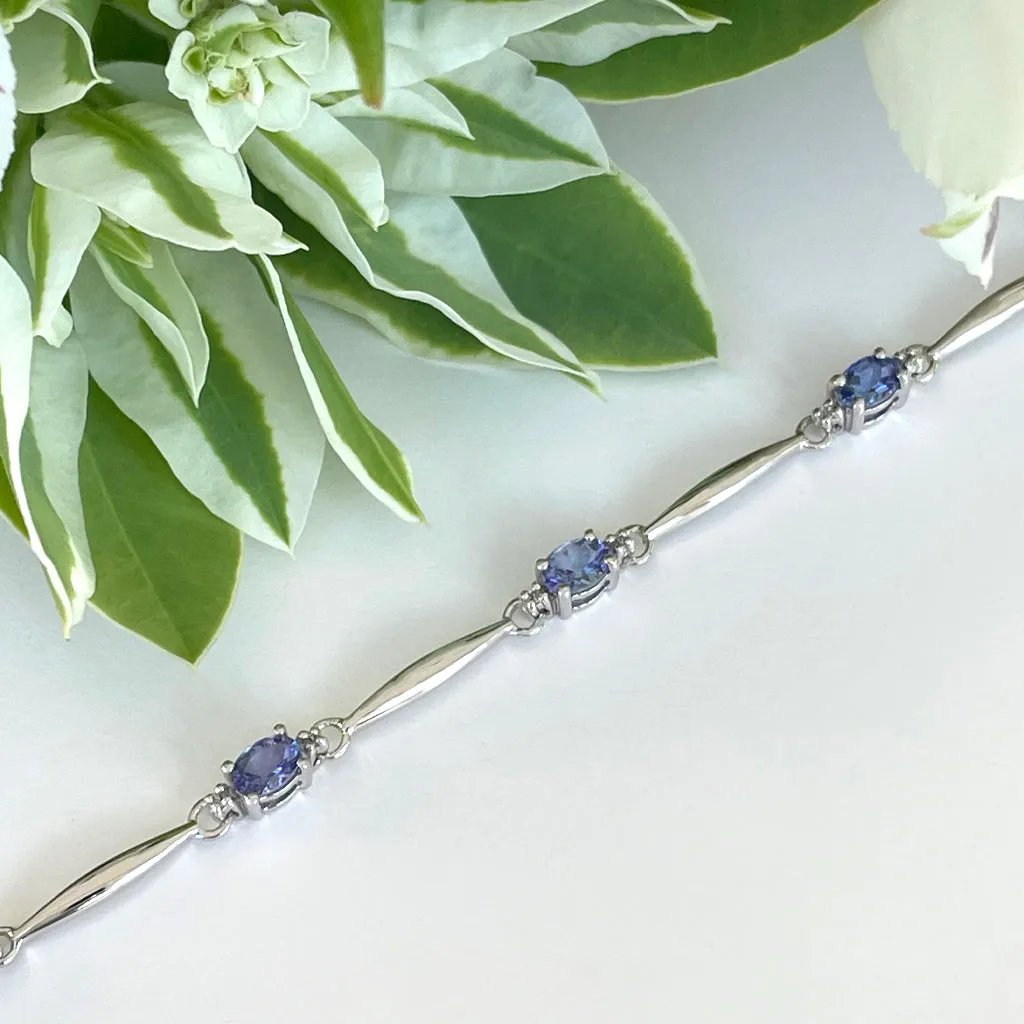 Silver Single Wave Oval Cut Tanzanite and Petite Silver Topaz Highlight Bracelet