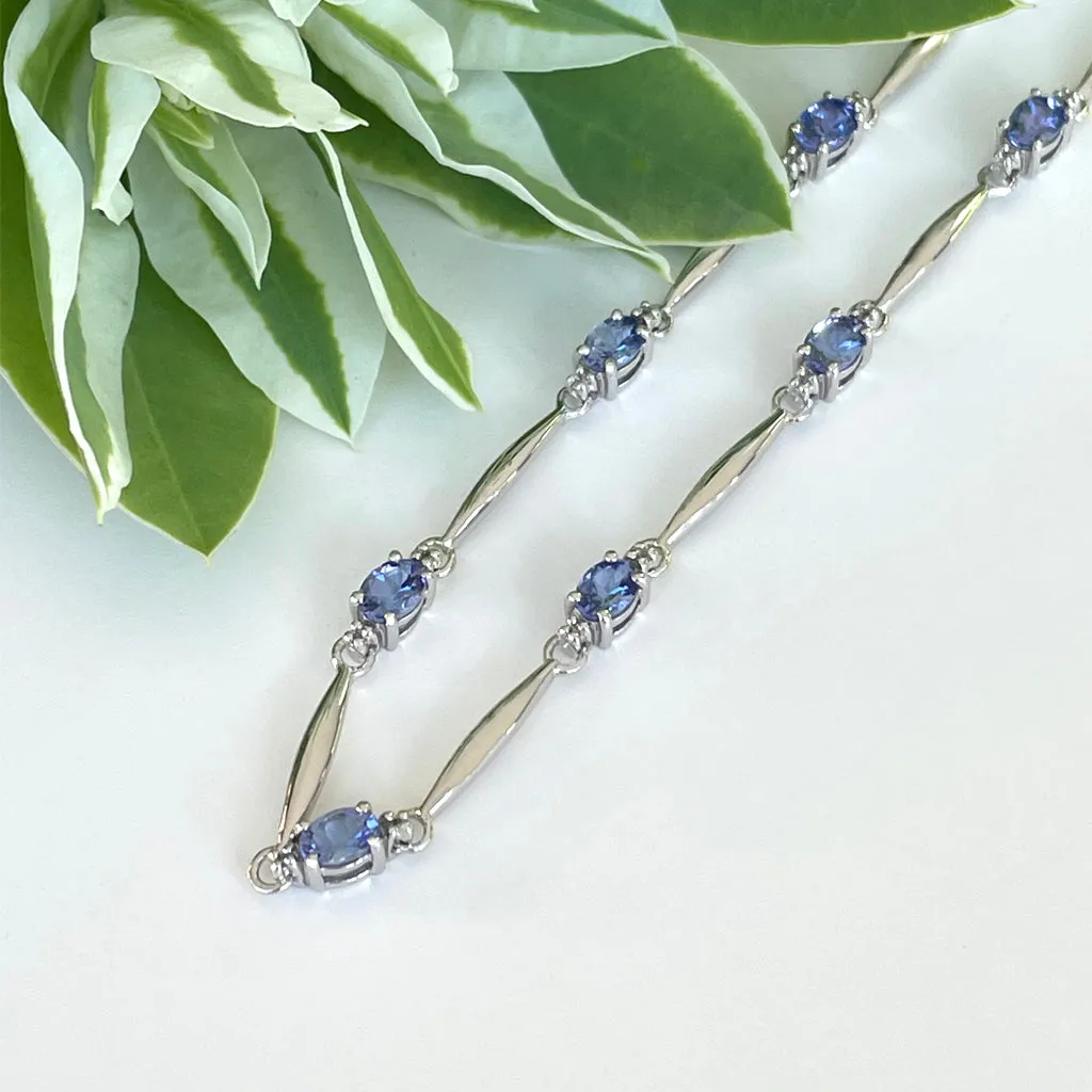 Silver Single Wave Oval Cut Tanzanite and Petite Silver Topaz Highlight Bracelet